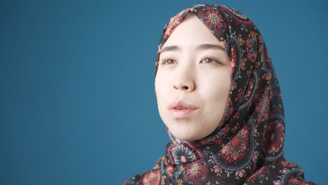 Innocent-and-beautiful-Muslim-Asian-woman-in-hijab-praying.-Loyal-asian-woman.